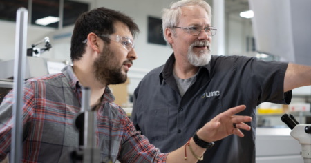 Skilled machinists working together Ultra Machining Company Technology Manufacturing